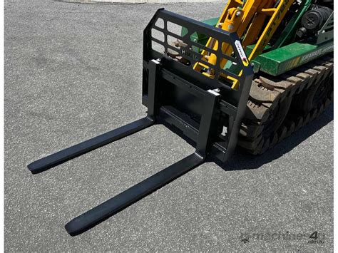 Photo of a Bobcat mini loader with pallet forks.