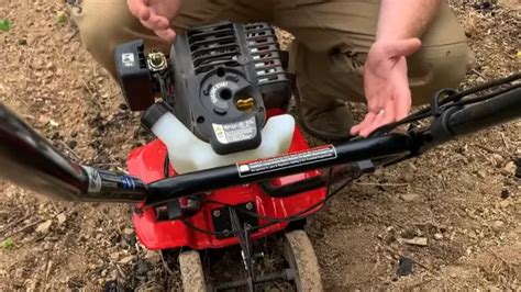 Thematic photo of a person inspecting a faulty garden tiller