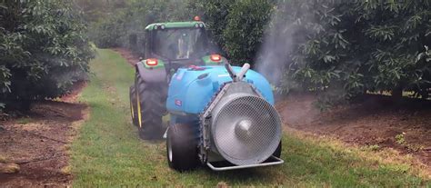 Thematic photo of an Agrola orchard sprayer in a blooming orchard