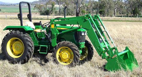 Thematic photo of a modern tractor with a front loader working in a field