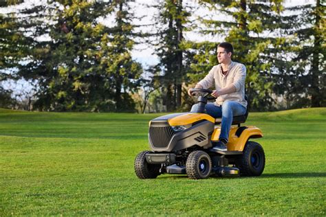 Thematic photo of a Stiga garden tractor on a green lawn with a house in the background