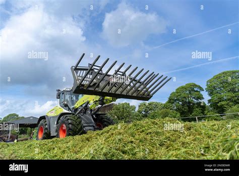 The Fliegl silage leveller/spreader working on a silage clamp with a tractor.