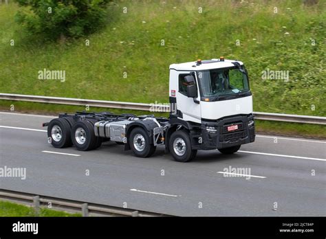The Renault Premium 4600 tractor unit, side view, on a road or at a truck stop, showcasing its design and size.