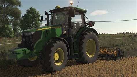 Schemat ciągnika John Deere Serii 7R z zaznaczonymi elementami sterowania i zawieszenia