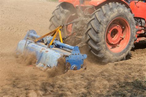 Thematic photo of a tractor rotary tiller working in the field