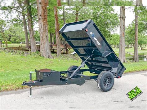 Thematic photo of a single-axle dump trailer in operation, possibly in an agricultural or municipal setting with up to 4 tons of cargo