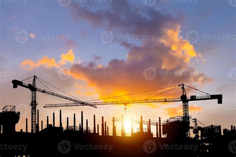 Thematic photo of a tower crane on a construction site at sunset