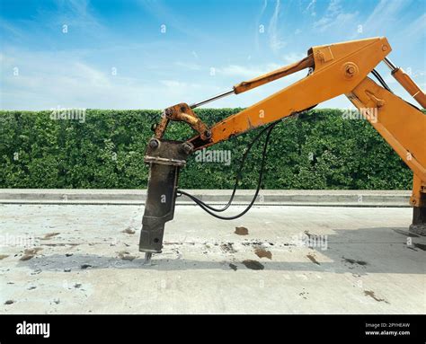 Thematic photo of a hydraulic drill connected to an excavator working on a construction site