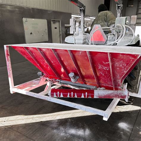 Lime pallets next to a lime spreader ready for refilling