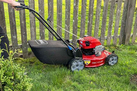 Thematic photo of a self-propelled petrol lawn mower in action on a large lawn, highlighting its convenience.