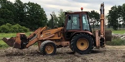The Case 580K backhoe loader at work, digging a trench