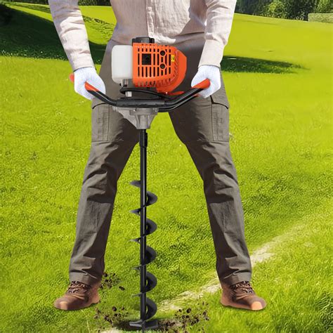 Thematic photo of a person operating a petrol auger in a garden