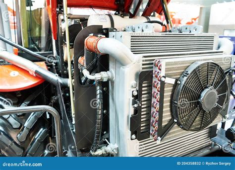 Thematic photo of a tractor engine with a visible radiator and fan.