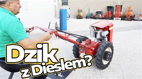 Schemat porównujący podwozie jednoosiowe i dwuosiowe rozrzutnika.