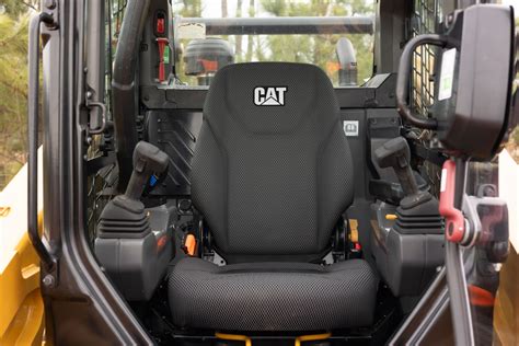 The interior of a ROPS cabin with controls and a comfortable heated seat for a loader operator.