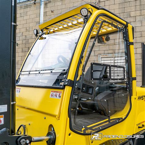 Thematic photo of a forklift operator in a cabin with a clear front windshield