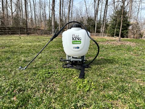 Thematic photo of a person operating an Oleo-Mac backpack sprayer in a field or orchard