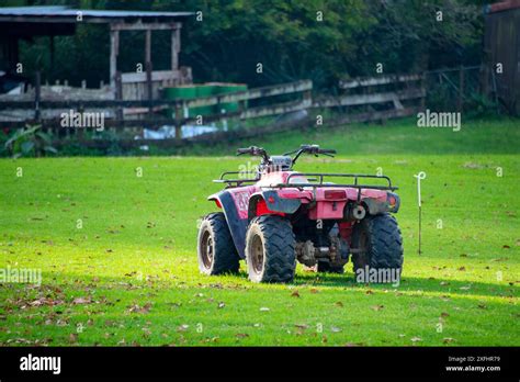 Thematic photo of a quad bike working on a farm, e.g., plowing snow or pulling a small trailer with hay.