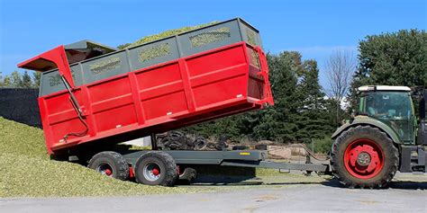 Thematic photo of a T710/2 dump trailer in an agricultural or municipal setting, possibly loaded with grain or rubble