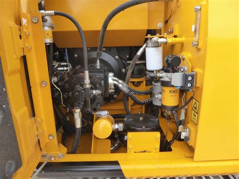 Photo of the control panel of a JCB 130 JS excavator highlighting buttons and indicators