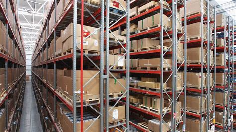 Thematic photo of a side-loading forklift transporting long metal profiles in a narrow warehouse aisle