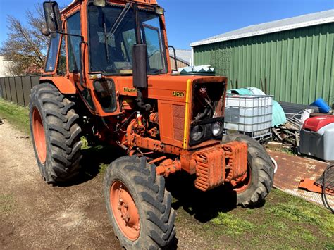 Thematic photo of a Belarus 920 tractor working in a field