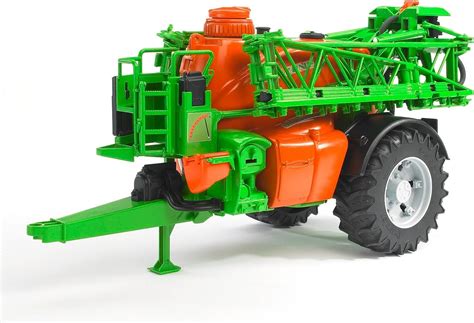 The Bruder 02207 Amazone trailed sprayer toy attached to a Bruder tractor in a simulated farm environment