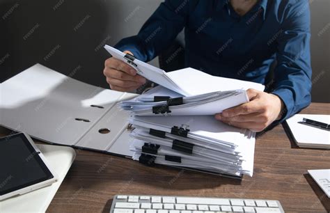 Thematic photo of a person holding documents related to vehicle registration or inheritance