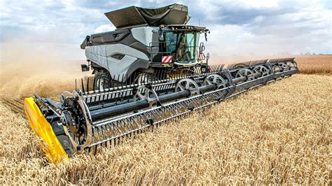 Thematic photo of a large agricultural combine harvester on a public road, followed by a pilot car.