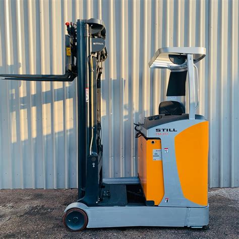 The Still FM-X17 reach truck in a warehouse setting, showcasing its compact dimensions and ability to operate in narrow aisles.