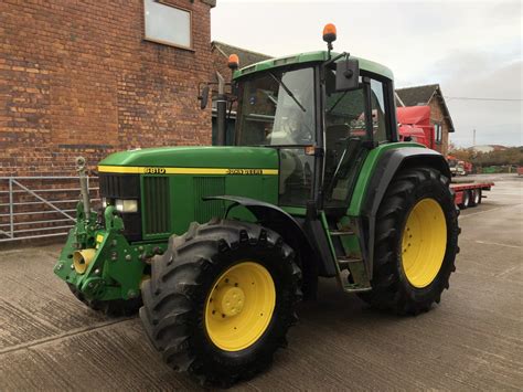 Zdjęcie przedstawiające ciągnik John Deere 6810 w trakcie prac polowych