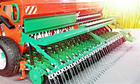 Zdjęcie przedstawiające różnorodne części zamienne do siewników, ułożone na stole warsztatowym