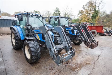 Thematic photo of Quicke frontal loaders in action on a farm