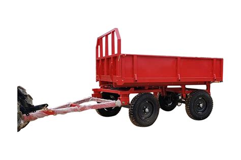 Thematic photo of a small dump trailer connected to a tractor or a utility vehicle on a farm