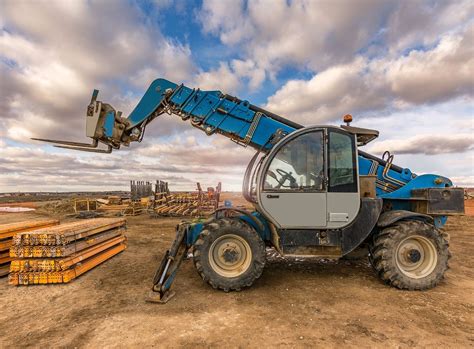Thematic photo of an off-road forklift working on a construction site or uneven terrain in a natural, industrial setting.