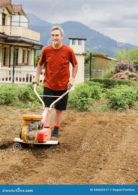 Thematic photo of a person operating a tiller in a garden