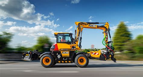 Thematic photo of a JCB wheeled excavator working on a road or construction site, showcasing its mobility