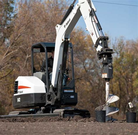 Diagram showing a Bobcat mini excavator with an auger attachment
