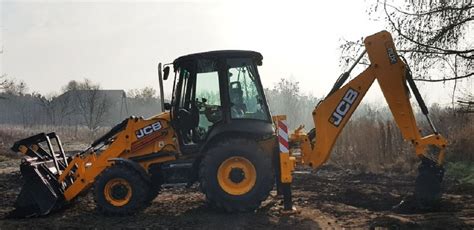 zdjęcie koparko-ładowarki pracującej na budowie
