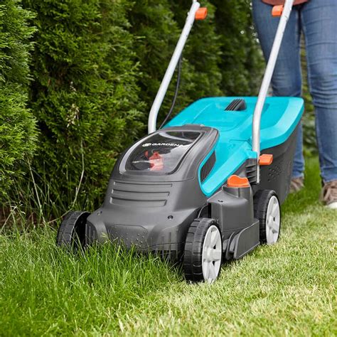 Thematic photo of a Gardena PowerMax electric lawnmower in a garden