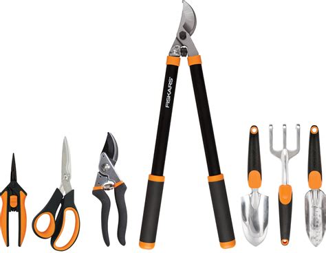 Thematic photo of various Fiskars tools, e.g., secateurs, scissors, axe, in a pleasant setting