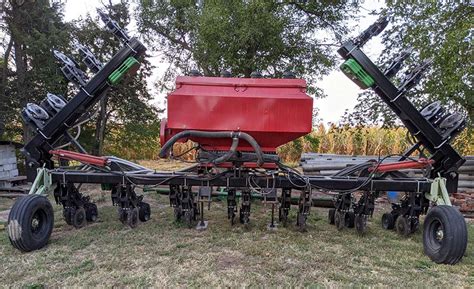 Thematic photo of a cover crop spreader/seeder in action on a field.
