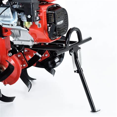 The Hecht 7100 petrol tiller with its various attachments