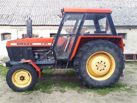 Zdjęcie przedstawiające ciągnik Ursus C-335 na tle polskiej wsi