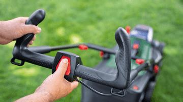 Photo showing a user operating the lawnmower with Ergoflex handles