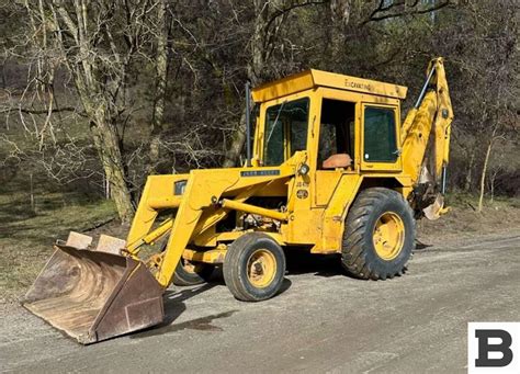 Thematic photo of a John Deere 410 backhoe loader at work