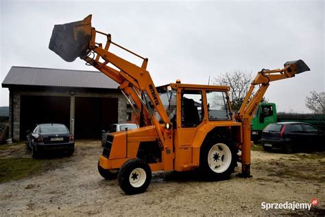 Thematic photo of an Ostrówek KTO-162 or NK-0451B koparko-ładowarka at work on a construction site or farm