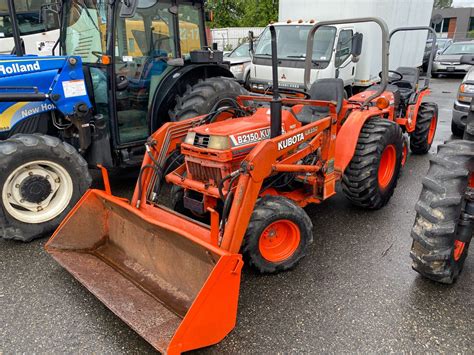 Thematic photo of a used Kubota tractor with a front loader (TUR) working in a field