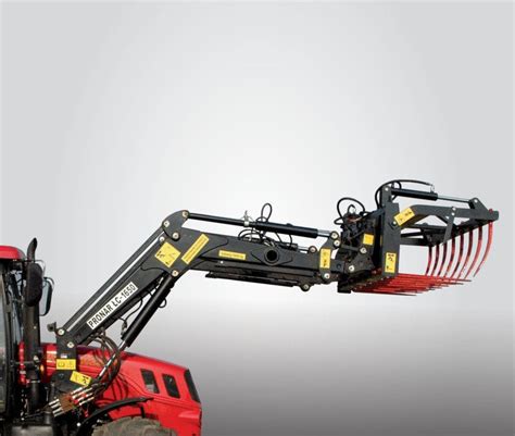 The Pronar LC3 front loader attached to a tractor, performing loading operations with a bucket, set in an agricultural field. The image highlights the loader's sturdy construction and its ergonomic design.