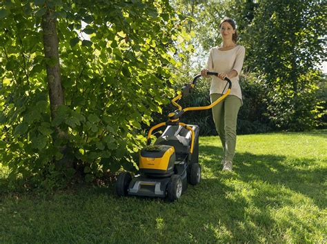 The STIGA logo and a modern cordless lawnmower in a green garden setting, emphasizing eco-friendliness.